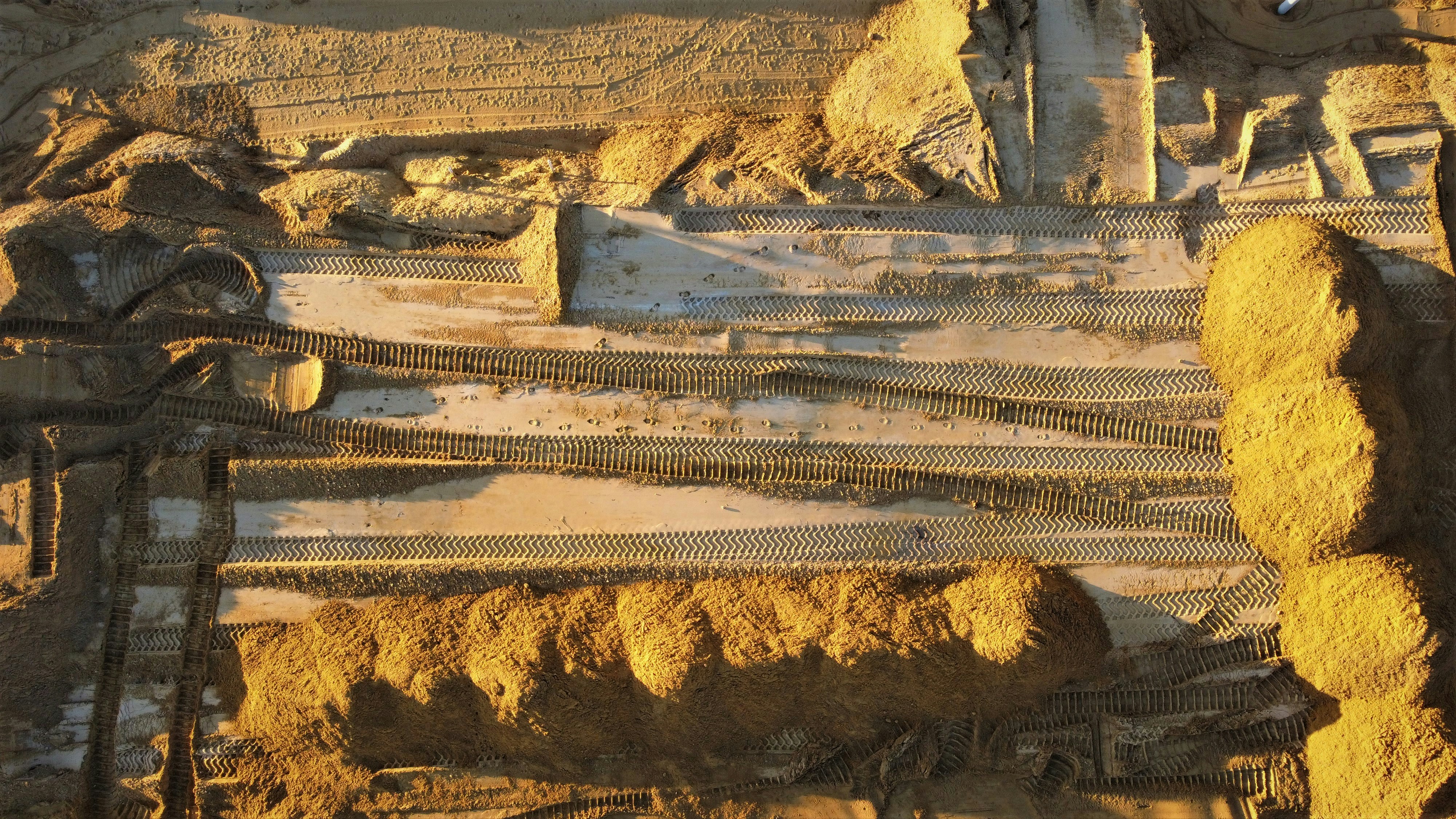 Aerial photograph of earthworks and construction tracks across a large site